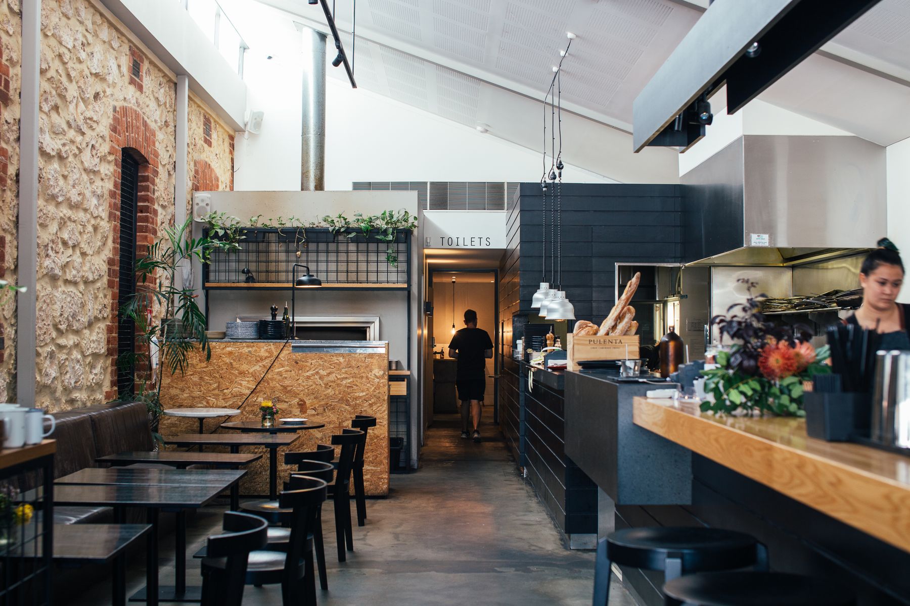 Sunlit modern café interior with tables and natural wood finishes
